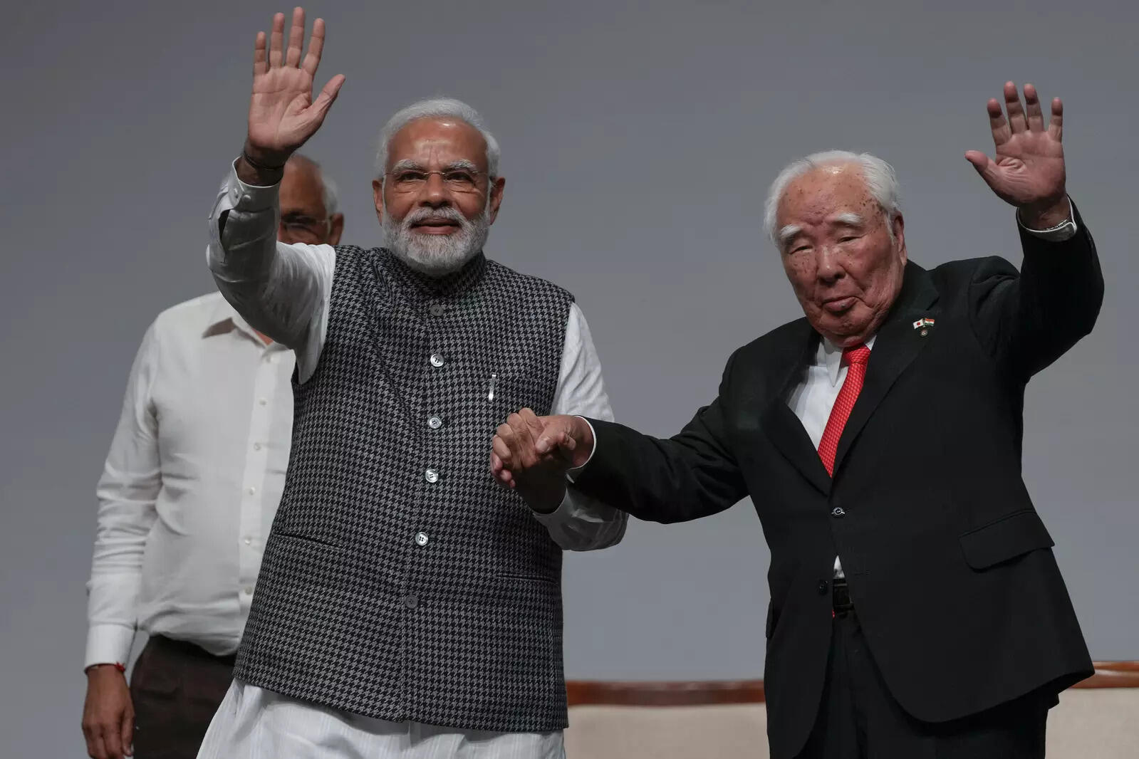  Indian Prime Minister Narendra Modi, left and Suzuki Motor Corp Chairman Osamu Suzuki wave during an event to mark 40 years of Suzuki's partnership with Maruti in India, Gandhinagar, India, Sunday, Aug. 28, 2022. (AP Photo/Ajit Solanki)