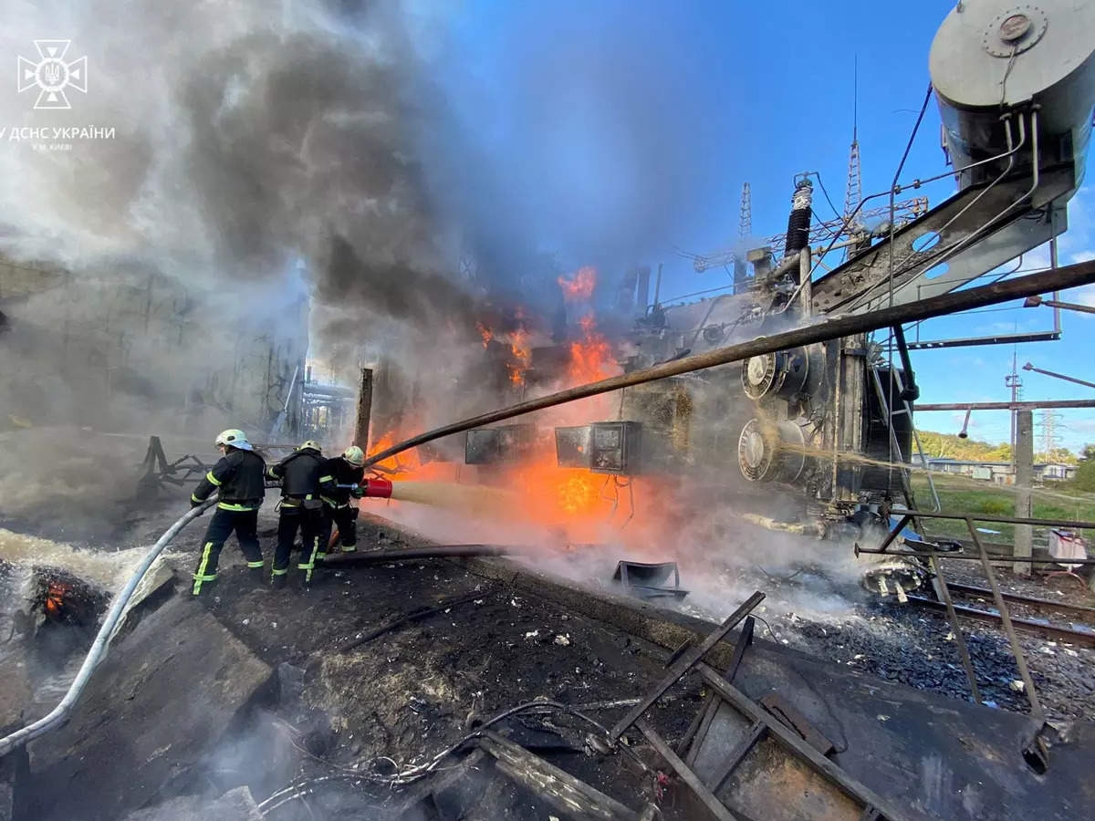  Firefighters work at a site of an infrastructure object damaged by a Russian missile strike, in Kyiv.