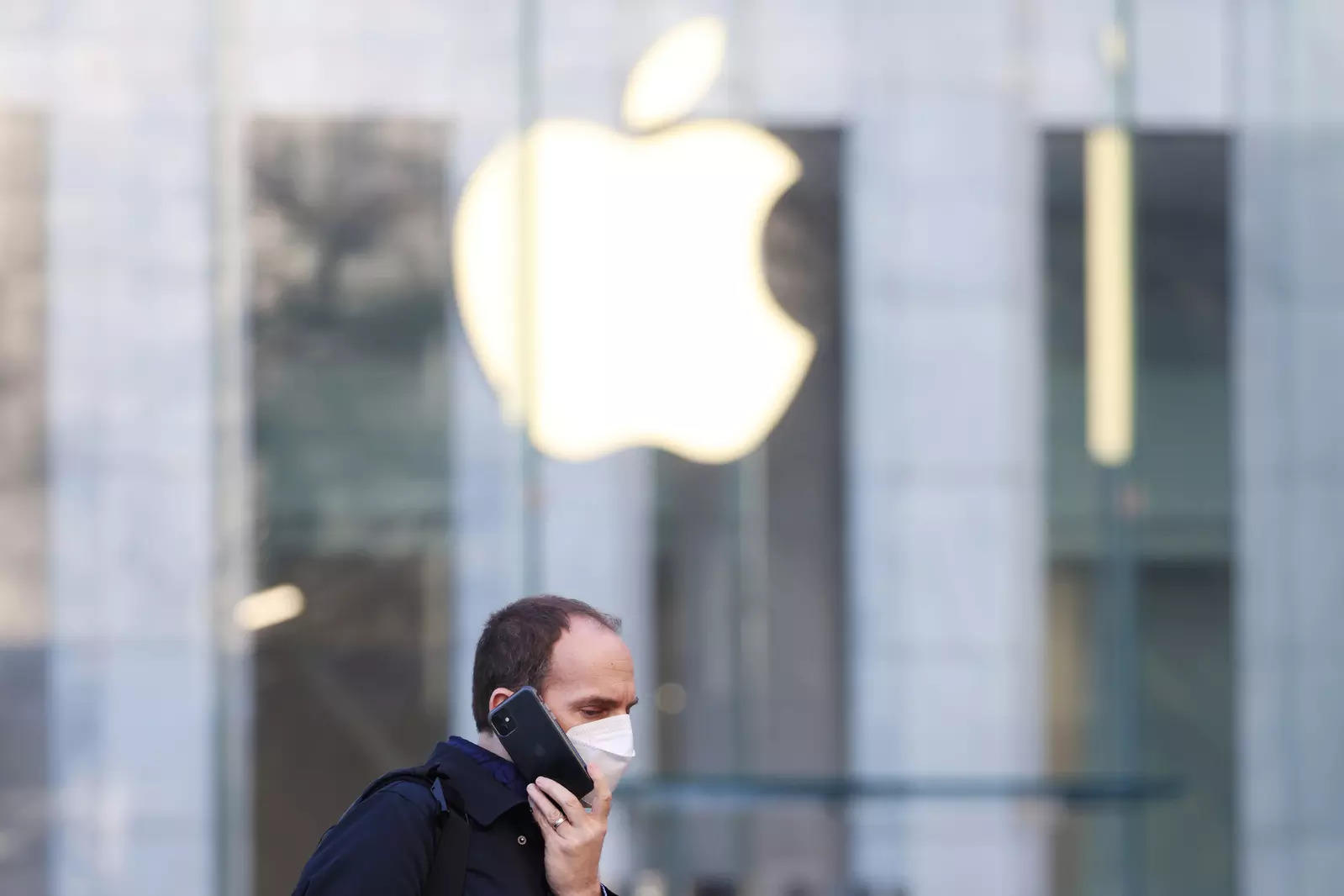  FILE PHOTO: A person uses smartphone near an Apple Store in Manhattan, New York City, U.S., February 11, 2022. REUTERS/Andrew Kelly