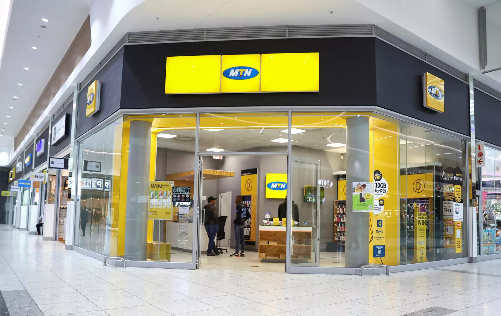  FILE PHOTO: Customers are seen at an outlet of South Africa's MTN Group at the Mall of the South in Johannesburg, South Africa, November 4, 2022. REUTERS/Siphiwe Sibeko