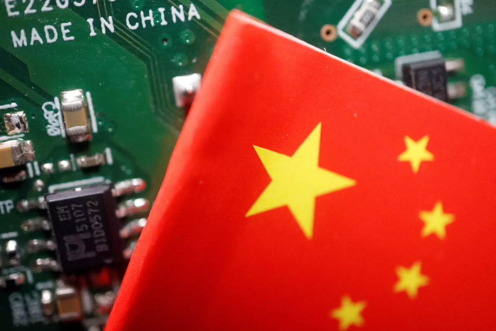  FILE PHOTO: A Chinese flag is displayed next to a &quot;Made in China&quot; sign seen on a printed circuit board with semiconductor chips, in this illustration picture taken February 17, 2023. REUTERS/Florence Lo/Illustration