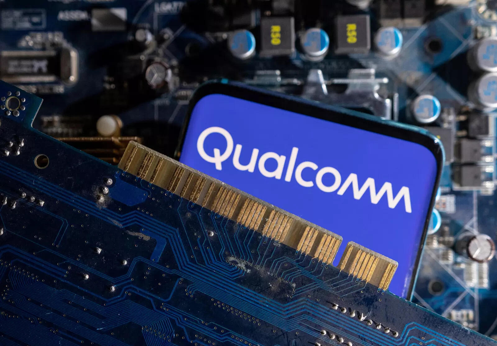  A smartphone with a displayed Qualcomm logo is placed on a computer motherboard in this illustration taken March 6, 2023. REUTERS/Dado Ruvic/Illustration