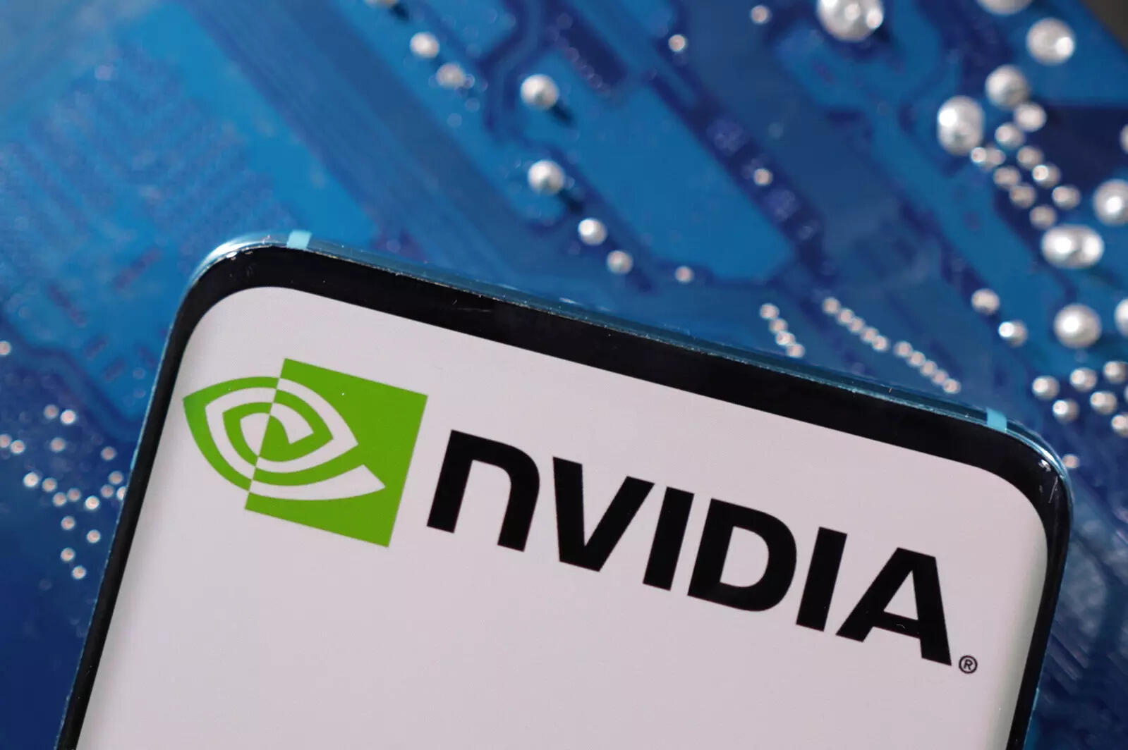  FILE PHOTO: A smartphone with a displayed NVIDIA logo is placed on a computer motherboard in this illustration taken March 6, 2023. REUTERS/Dado Ruvic/Illustration