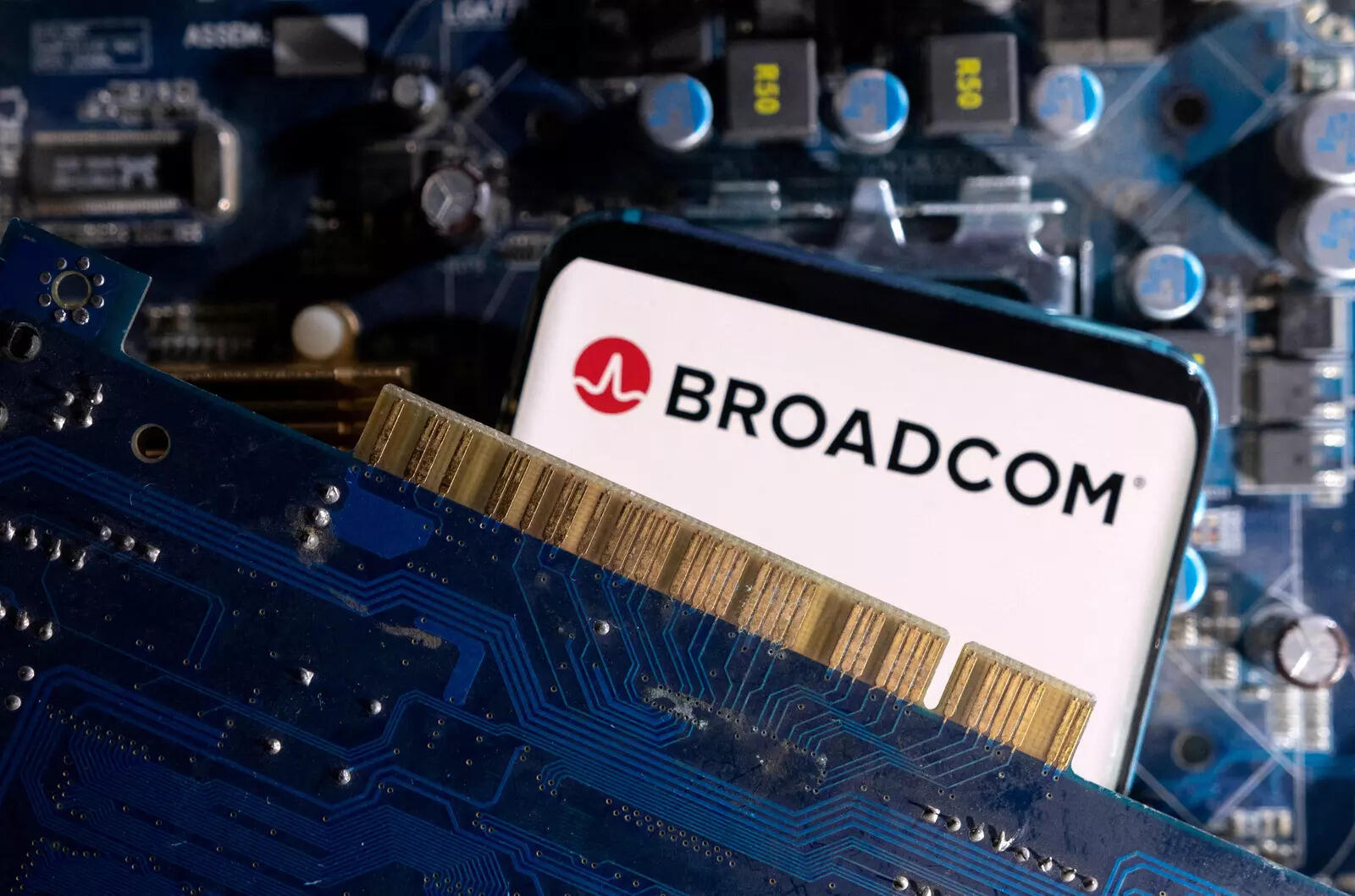  FILE PHOTO: A smartphone with a displayed Broadcom logo is placed on a computer motherboard in this illustration taken March 6, 2023. REUTERS/Dado Ruvic/Illustration/File Photo