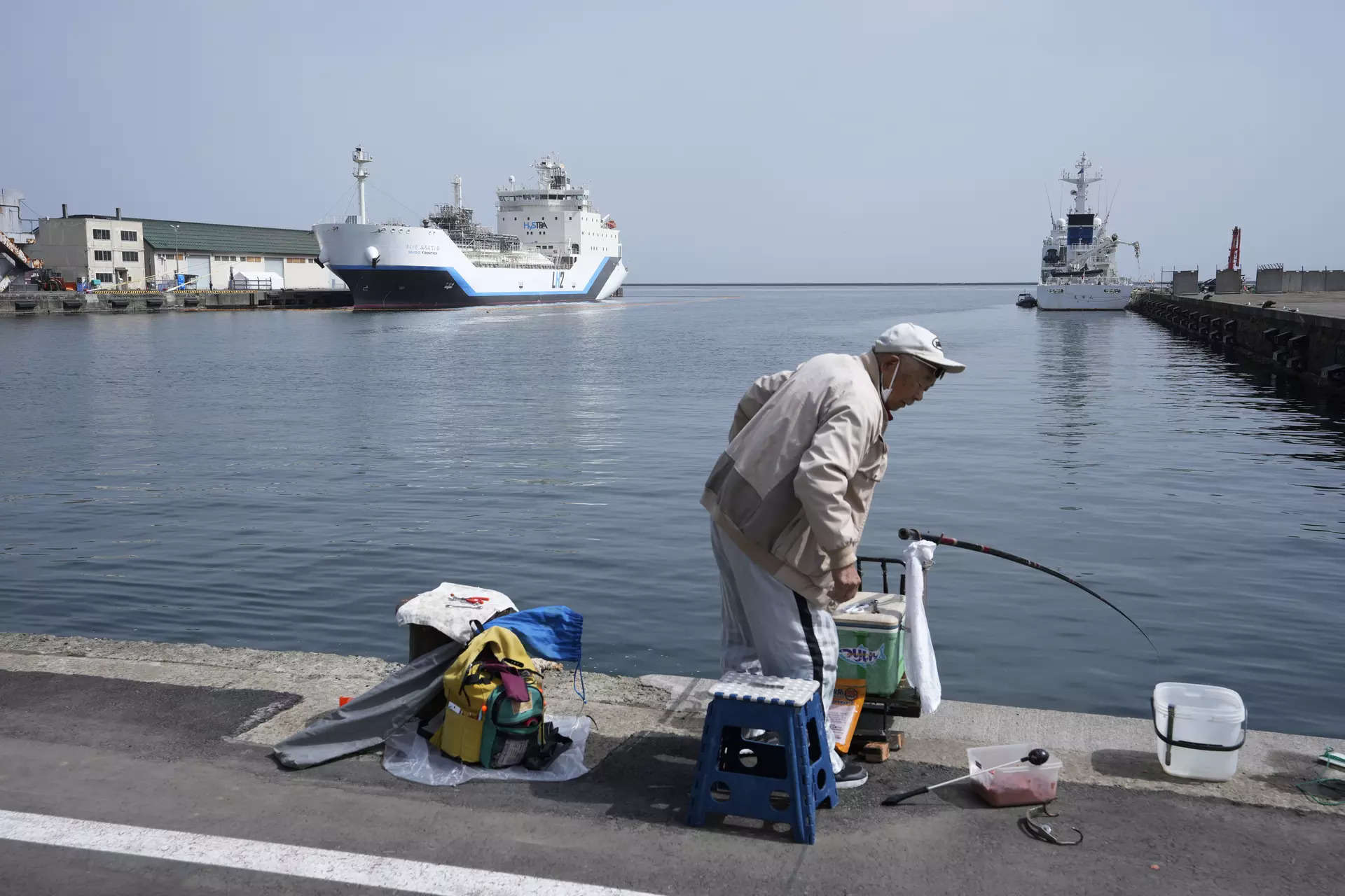 <p>A man tries to catch fish at a pier where a liquefied hydrogen carrier is docked in Otaru, northern Japan, Friday, April 14, 2023. U.S. Energy Secretary Jennifer Granholm took a tour Friday on the Suiso Frontier, a liquefied hydrogen carrier, the day before the G-7 ministers' meeting on climate, energy and environment. (AP Photo/Hiro Komae)</p>