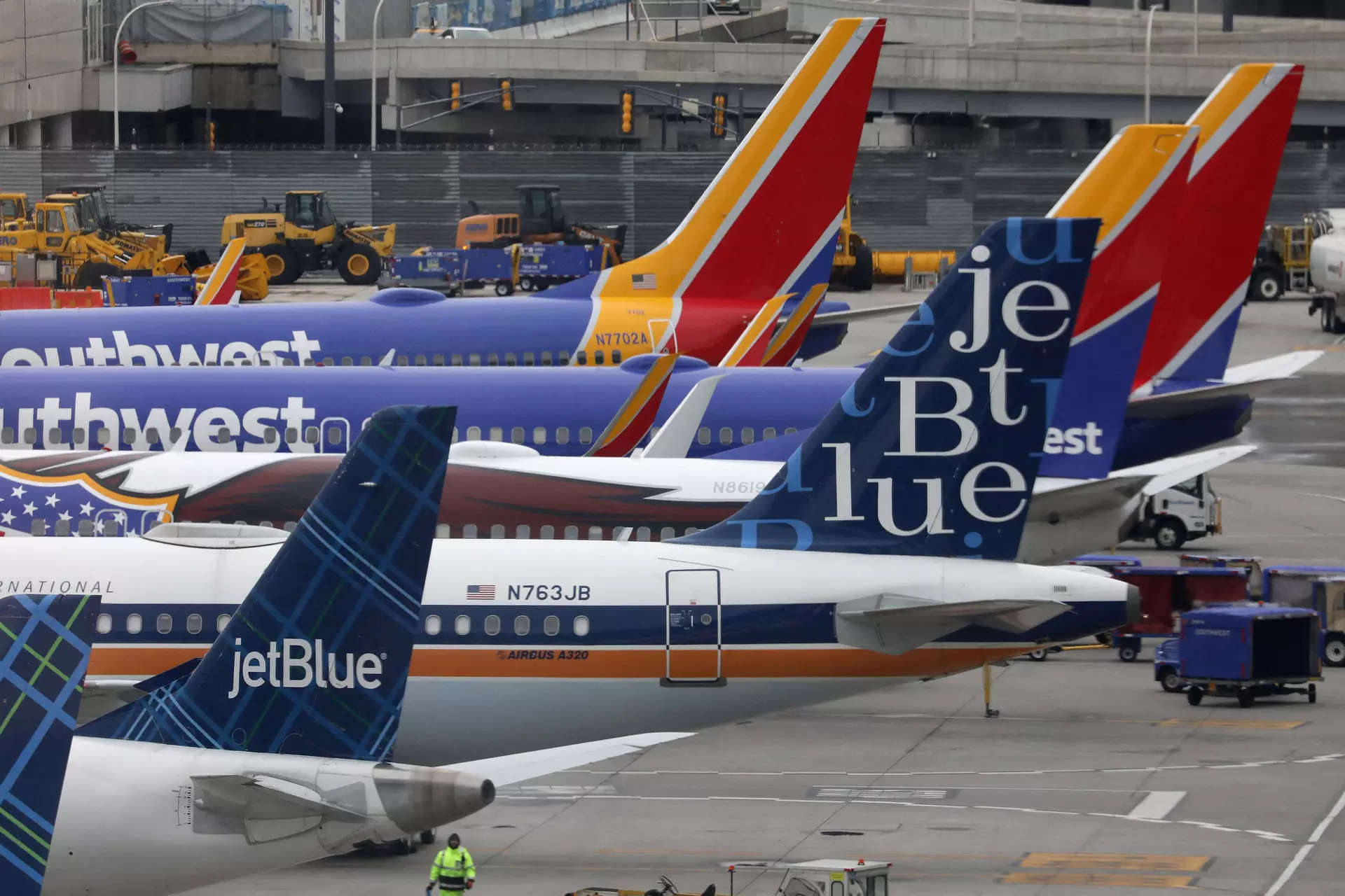 <p>FILE PHOTO: JetBlue and Southwest Airlines planes are parked at the LaGuardia Airport in New York City, U.S. March 4, 2023.  REUTERS/Chris Helgren/File Photo</p>