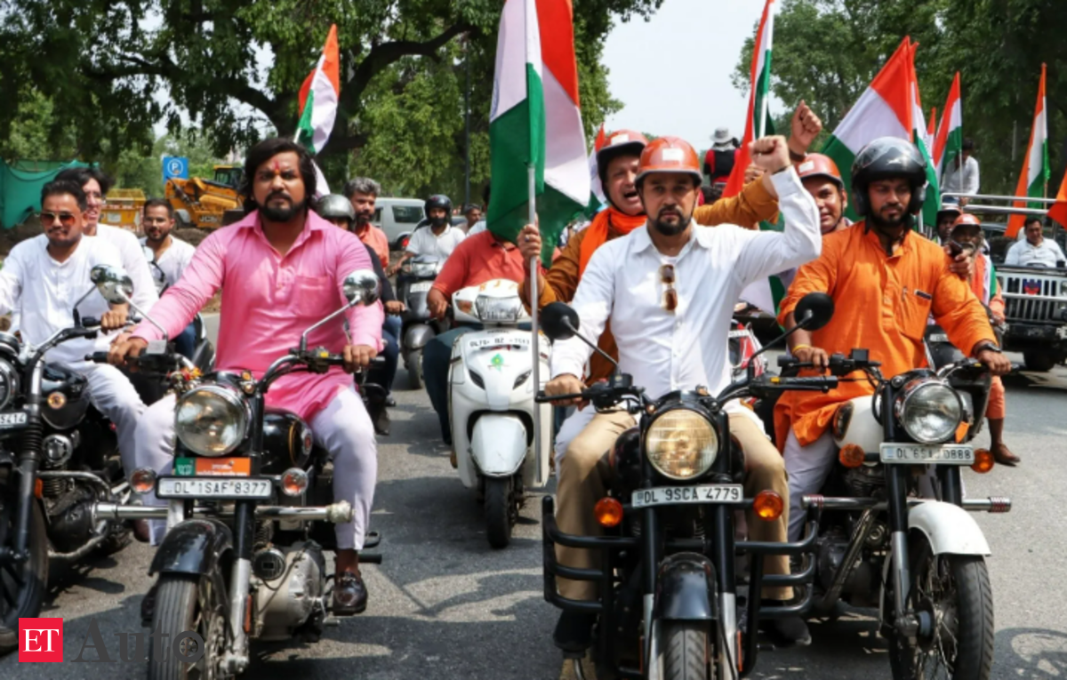 ahead-of-racing-event-in-up-union-min-anurag-thakur-rides-bike-with-motogp-riders-et-auto