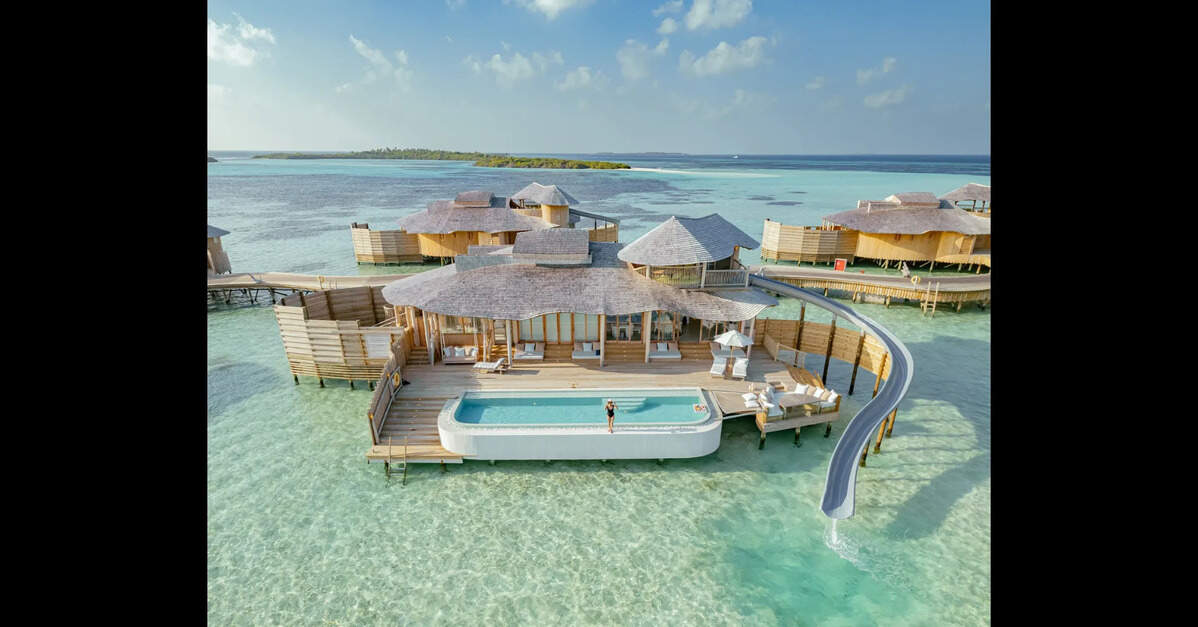Aerial view of a luxurious overwater villa with a private pool at a Soneva resort in the Maldives.